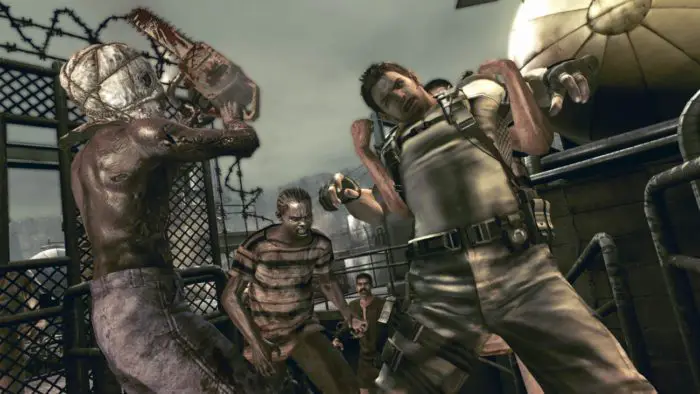Chris Redfield struggles against an infected Majini holding him from behind while another Majini approaches Chris with a raised chainsaw.
