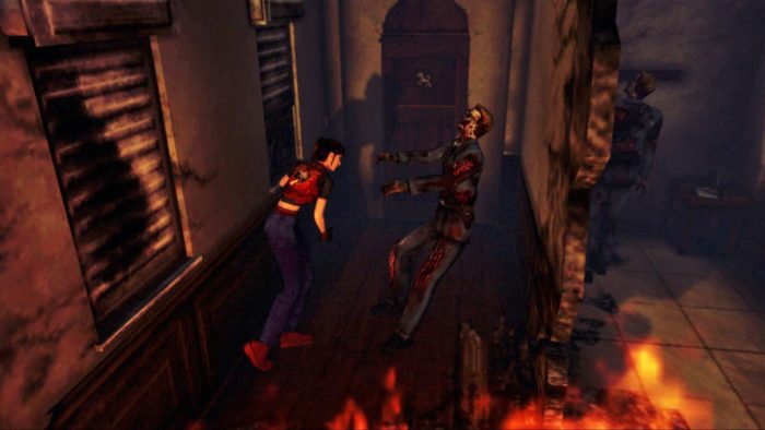 Claire Redfield knifes a zombie next to a large hole in the wall in a burning building.