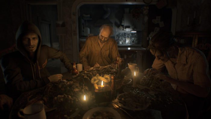 Jack, Marguerite, and Lucas Baker sit at a table full of disgusting, inedible food while watching the player.