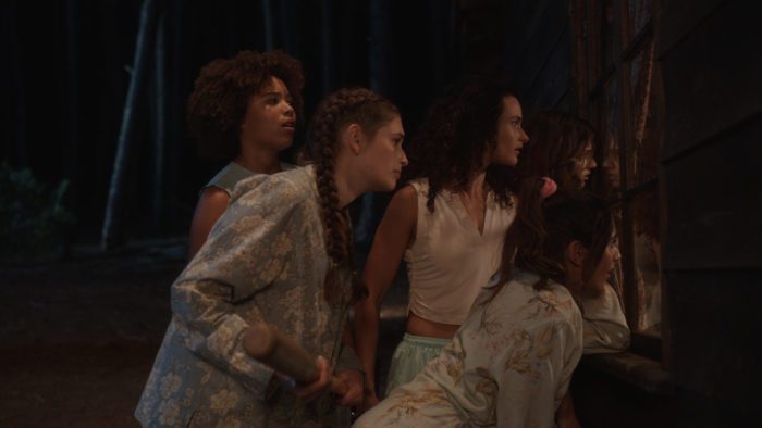 Dana (Hannah Gonera), Ashley (Reze-Tiana Wessels), Maeve (Frances Sholto-Douglas) and Breanie (Alex McGregor) trying to figure out how safe they are in Slumber Party Massacre