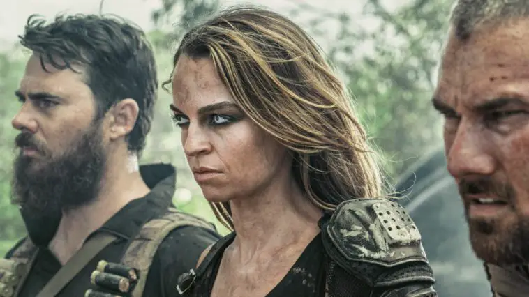 Barry, Brooke and Rhys stand stoic as they look at the road ahead of them in Wyrmwood: Apocalypse
