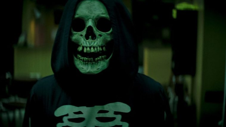 A hooded figure in a mask with a skeleton T shirt in Fear Street