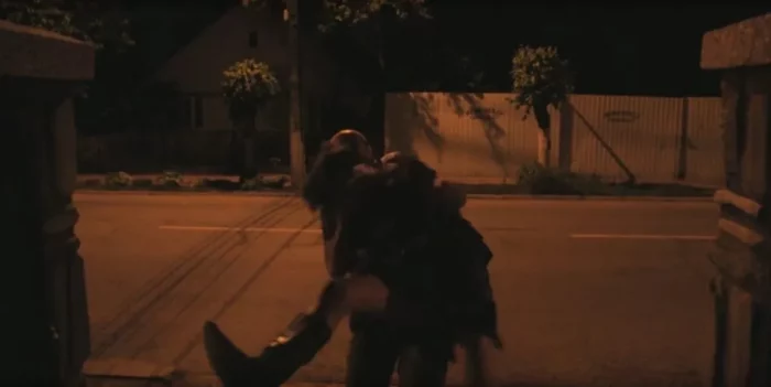 Adrian (Adrian Țofei) kidnaps Sonya (Sonia Teodoriu) on a dimly-lit street.