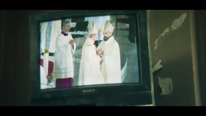 Padre Vergara sees himself superimposed on a TV with the Pope and Cardenal Santoro