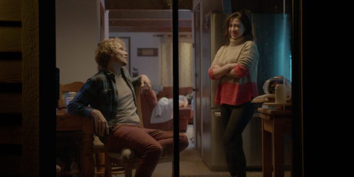 Michael and Sarah catch up in the cabin kitchen in Old Strangers