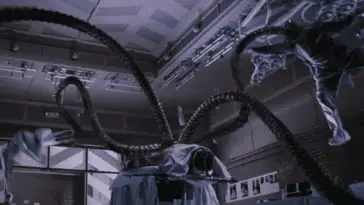 Doc Ock unconscious on the surgical table while the tentacles pick up and throw around the doctors in the operating theatre