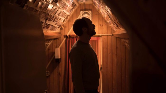 Bjørn investigates an attic covered in pictures in Speak No Evil