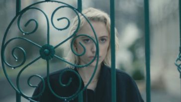 Julia stares through an iron gate in Watcher