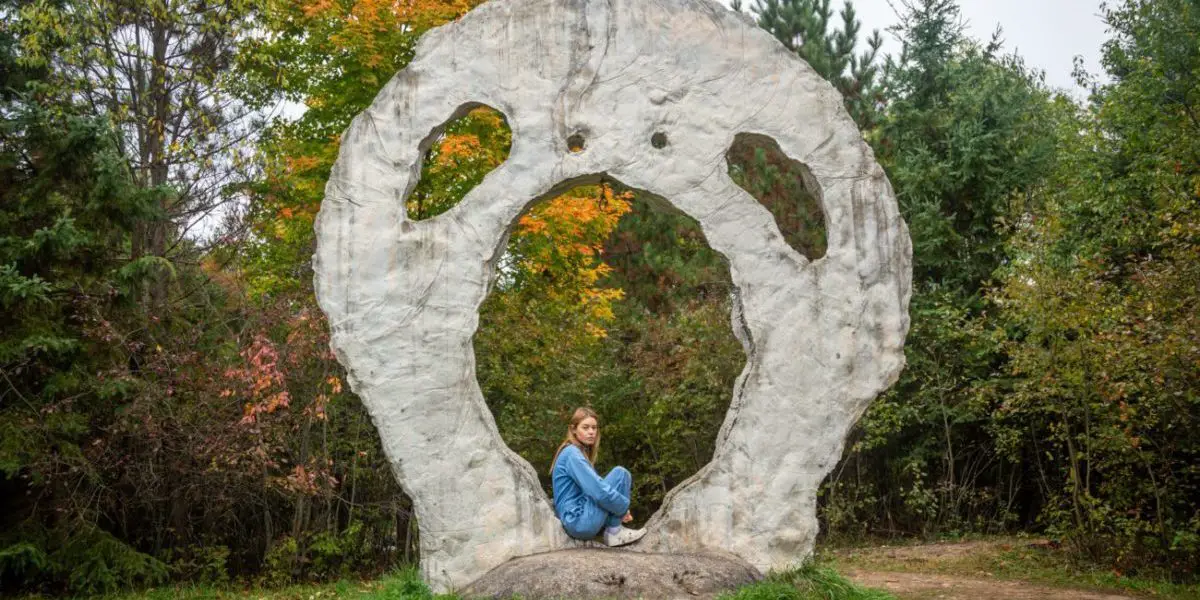 Aurora sitting in an alien-shaped rock formation