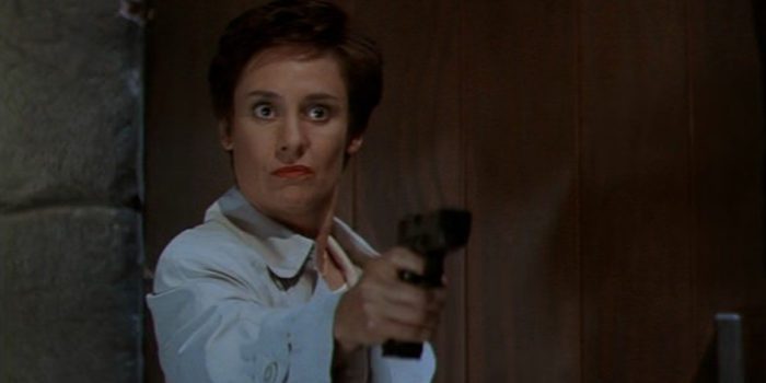 Laurie Metcalf as Debbie Loomis from Scream 2, seen here pointing a gun.