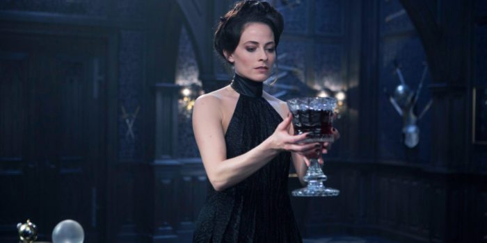 Lara Pulver as Semira from Underworld Blood Wars, seen here holding a large glass chalice of what appears to be blood. 