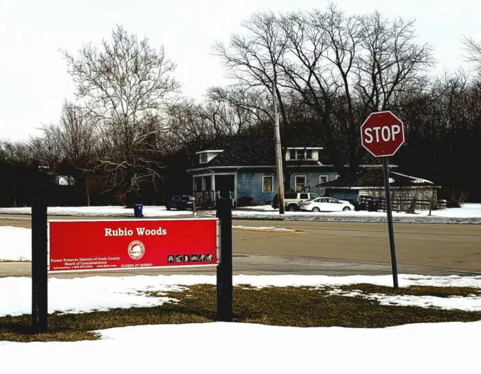 The red sign for Illinois Forest preserve's Rubio Woods.