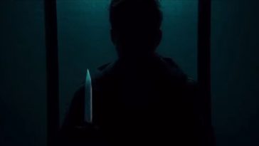 A Shadowy figure holds a glistening knife in Dark Glasses