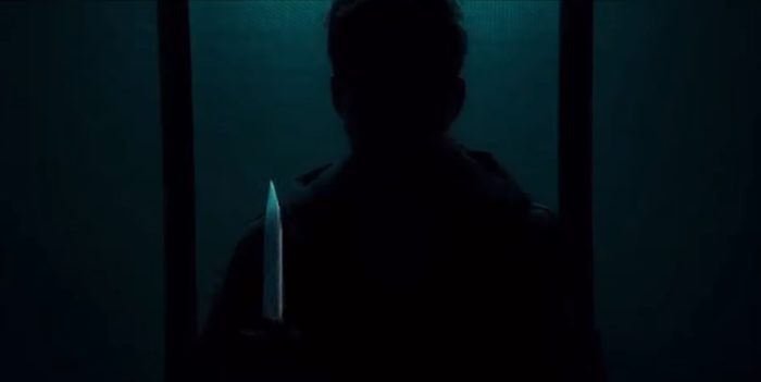 A Shadowy figure holds a glistening knife in Dark Glasses