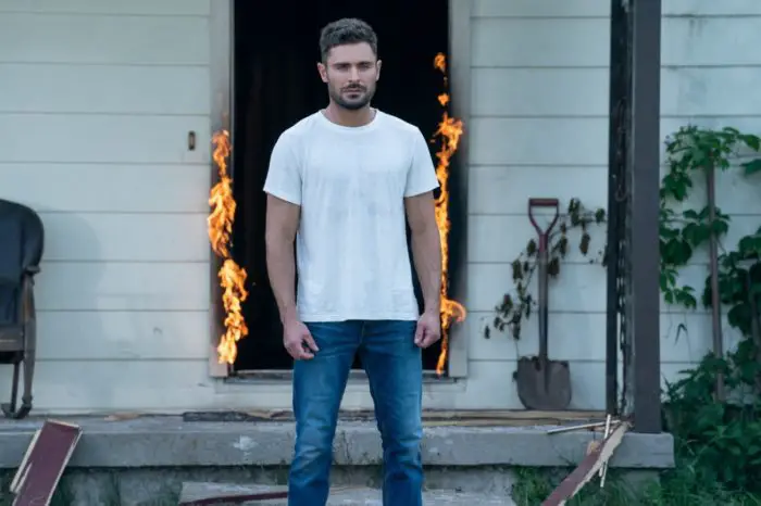 Andy stands in front of a flaming doorway in Firestarter (2022)