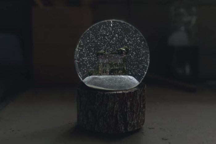 a snnowglobe sits atop a stand