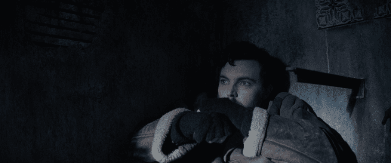 Shepherd: Eric Black (Tom Hughes) covers in fear, a knife embedded in the wall beside him