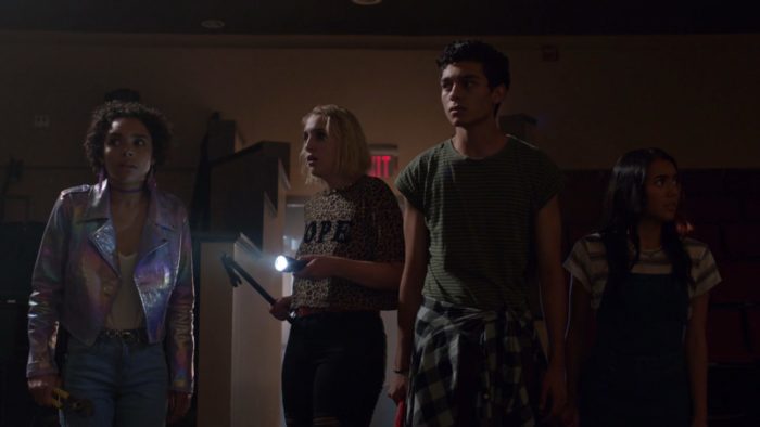 The cast of Student Body stands in a dark theater in Student Body