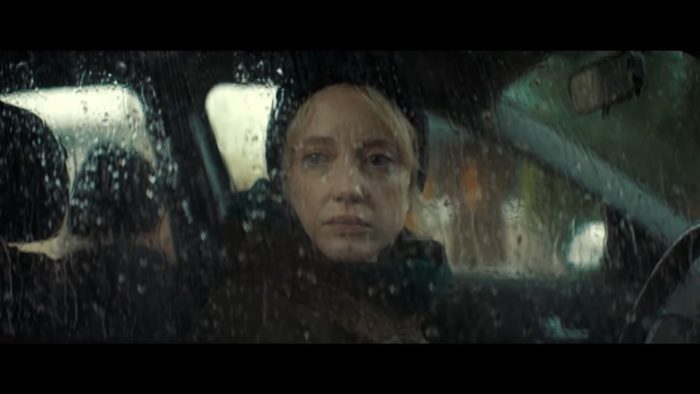 Laura watches longingly from her car in the rain as Marie and Megan live happily