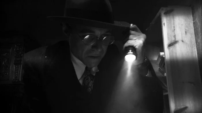 A detective stumbles upon a horrifying site with his flashlight.