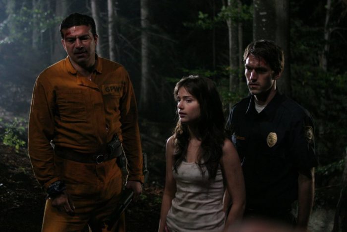 The crew of correctional officers and convicts makes its way through the woods, with hopes of finding a town...or a phone.