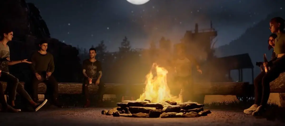Counselors gather around a campfire in The Quarry