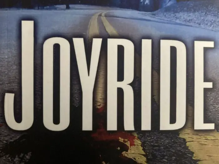 The title Joyride sits above blood spattered pavement