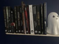 A bookshelf featuring multiple works by Jack Ketchum