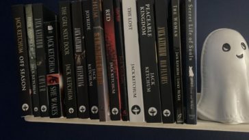 A bookshelf featuring multiple works by Jack Ketchum