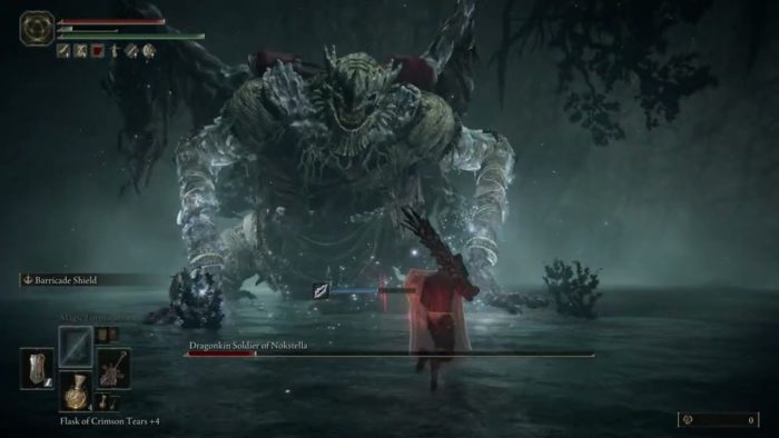 a large dragon-like humanoid crawls towards a warrior wielding a large sword
