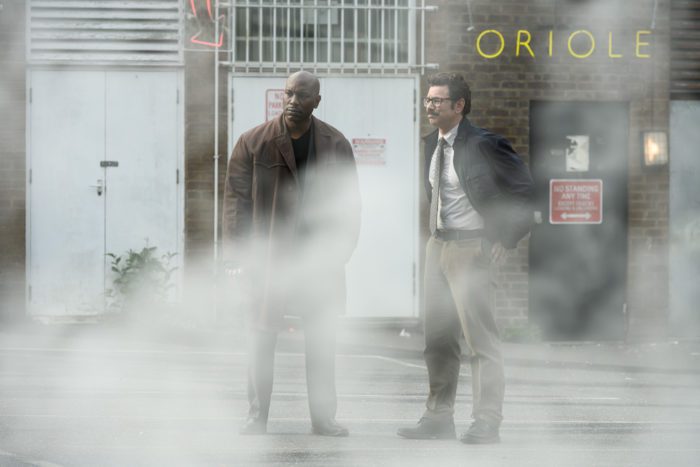 Two detectives standing in some fog
