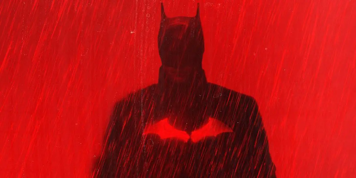 The Batman poster depicting Batman in the rain over red hues.