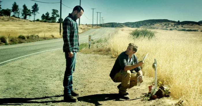 Justin and Aaron looking at something on the side of the road