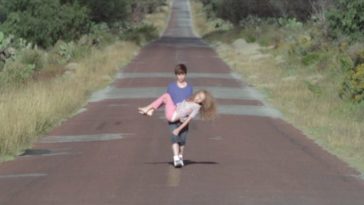Daniel carries Camila down a long stretch of The Infinite Highway in The Incident