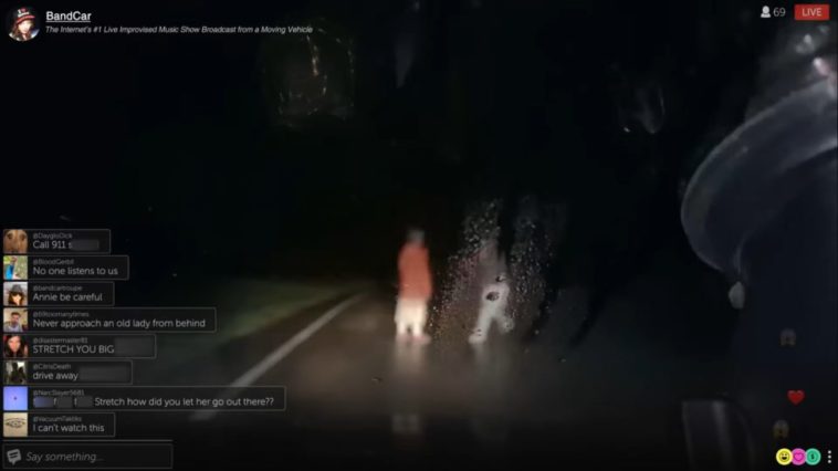Two people seen through a wet dashcam