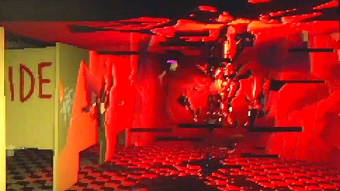 a red, glitch creature approaches the player in a washroom