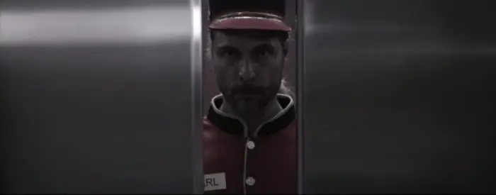 Oliver becoming Karl watches the elevator doors close in The Incident