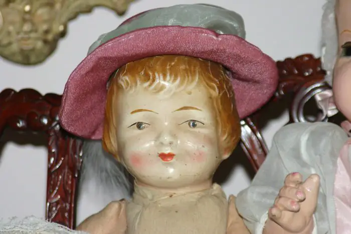 A vintage doll smiles.