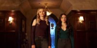 Hope and Lizzie stand in a foyer smiling in LEgacies