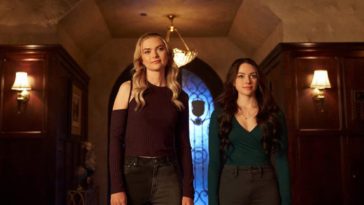 Hope and Lizzie stand in a foyer smiling in LEgacies