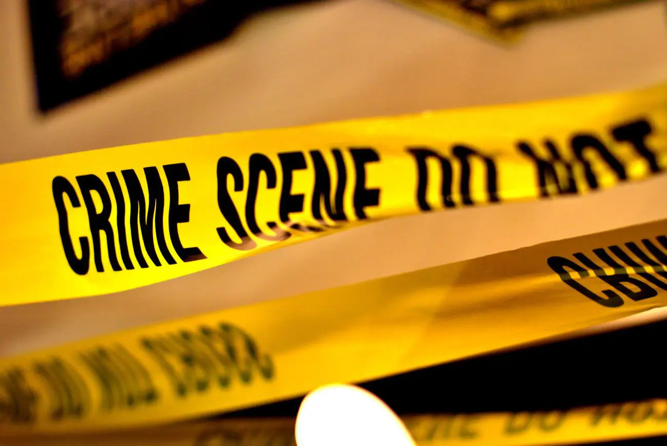A closeup of black and yellow crime scene tape.