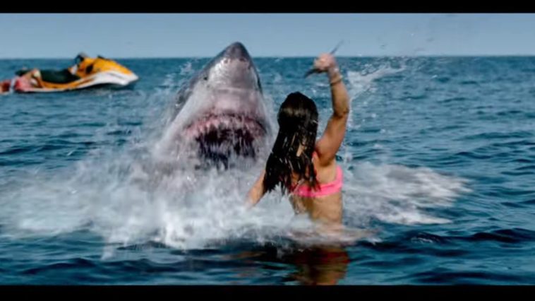 A woman raises a knife to an attacking shark in Shark Bait