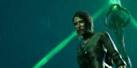 A woman stands in the rain next to a green glowing obelisk in The Chant