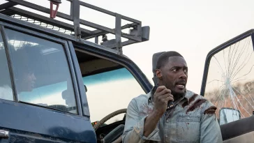 Idris Elba looking scared by a car