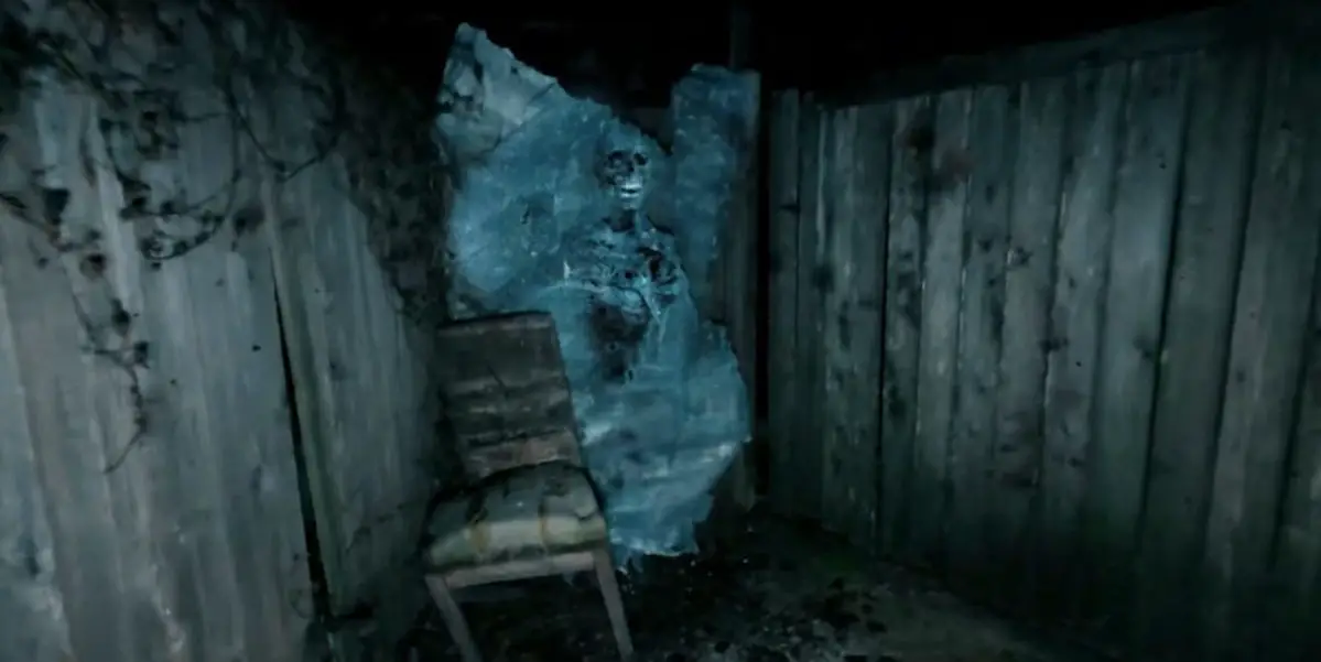A skeleton trapped in ice sits perpendicular to two parallel fences with an armless chair sitting beside it in A Town Full of Ghosts