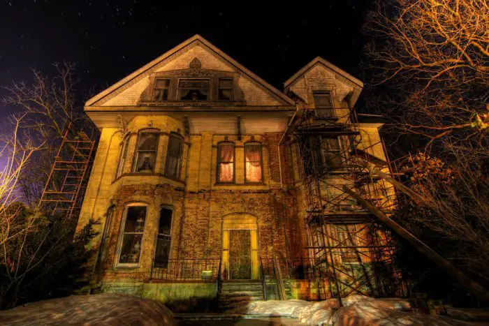 The front of an old house in the darkness.