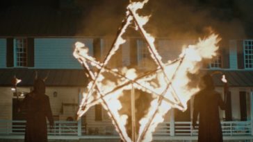 Cult members set a symbol ablaze on the front lawn of a house in The Long Night