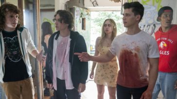 a blood covered Uriah Shelton exchanges words with Drew Schied while the rest of the cast stands behind them in Unhuman