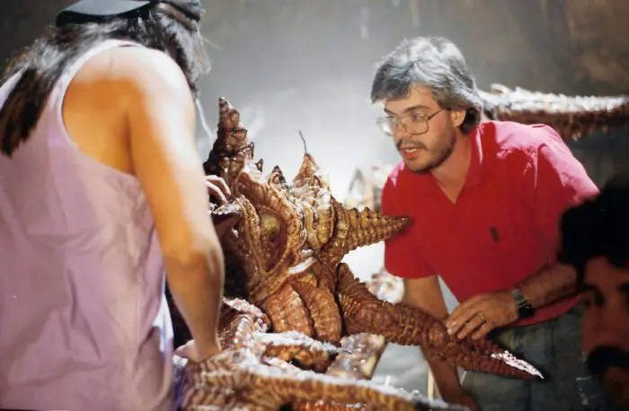 Bart Mixon and another crew member inspecting a giant spider looking creature.
