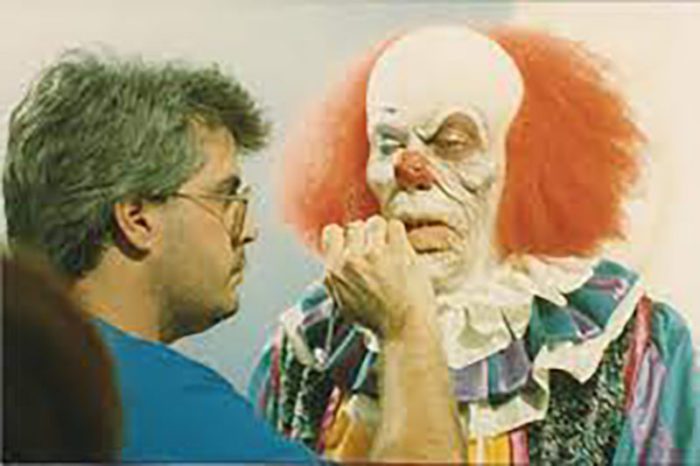 Bart Mixon touching up Pennywise's disfigured lip makeup.
